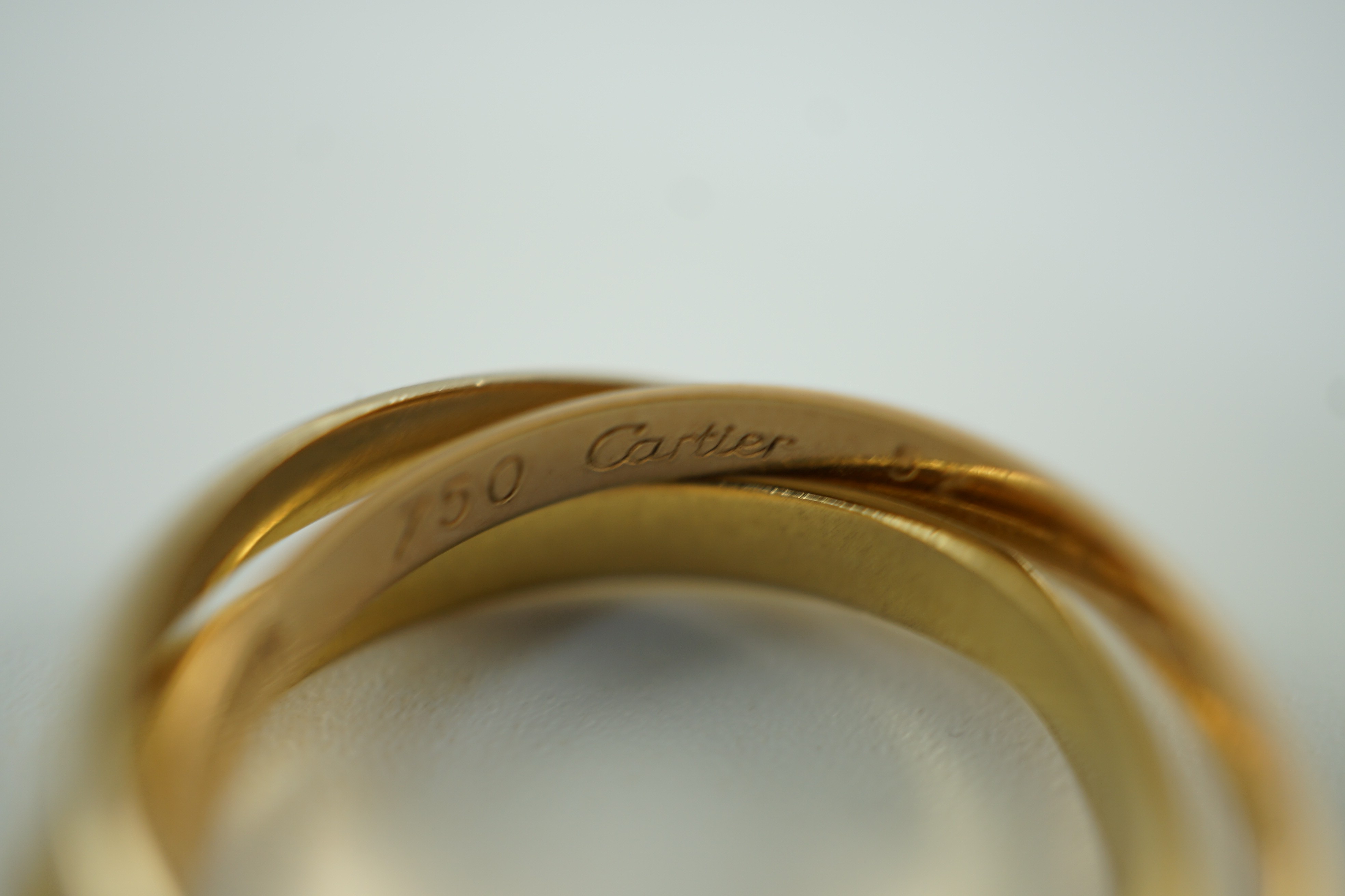A modern 18ct three colour Cartier 'Russian' triple wedding band